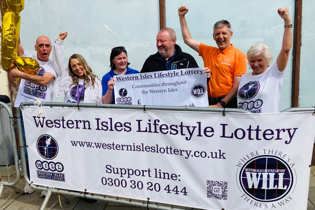 People behind Western Isles Lifestyle Lottery banner