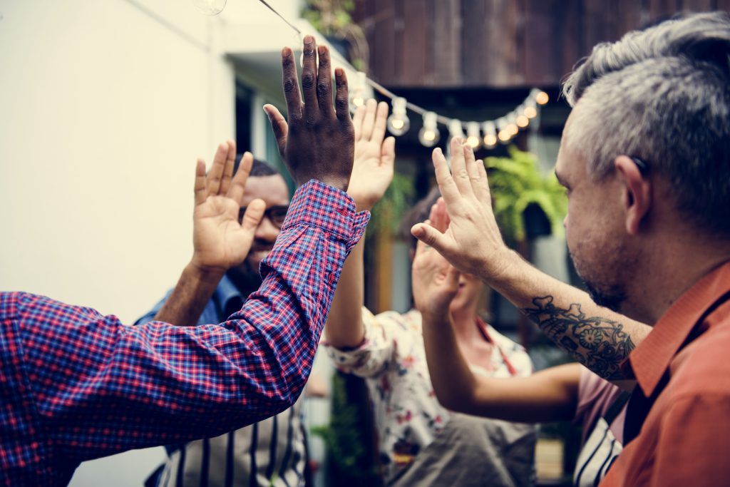 People celebrating starting a community lottery